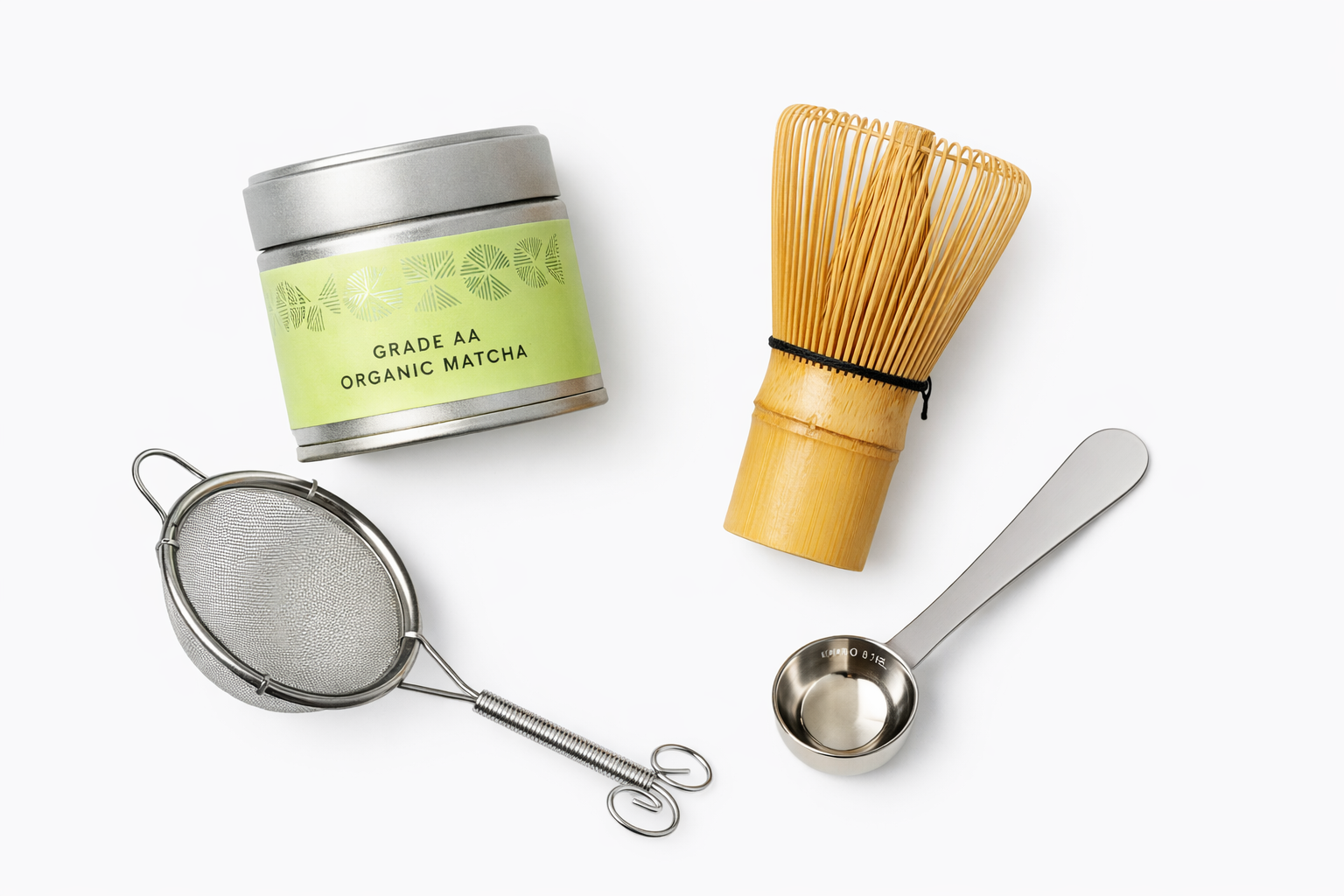 Matcha tea set with a canister, whisk, sieve, and scoop on a white background


