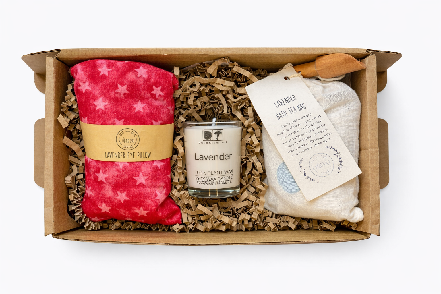 Gift set with lavender eye pillow, candle, and bath bag in a box on a white background
