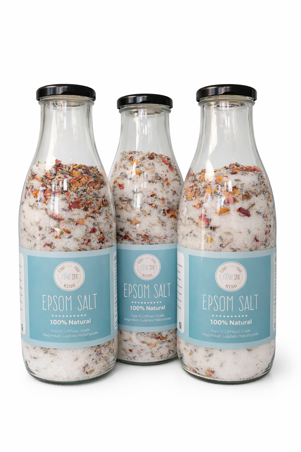 Three bottles of Epsom salt with visible ingredients on a white background