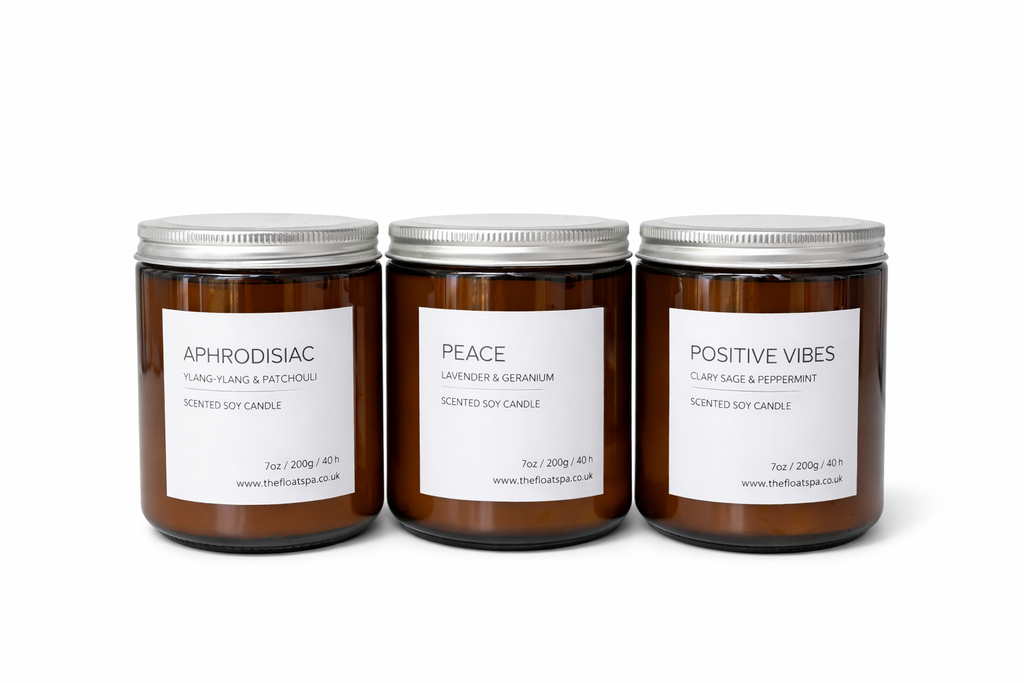 Three candles with labels 'Aphrodisiac', 'Peace', and 'Positive Vibes' on a white background.

