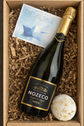 Bottle of Nozeco sparkling wine in a box with a card and Epsom Salt Bath Bomb