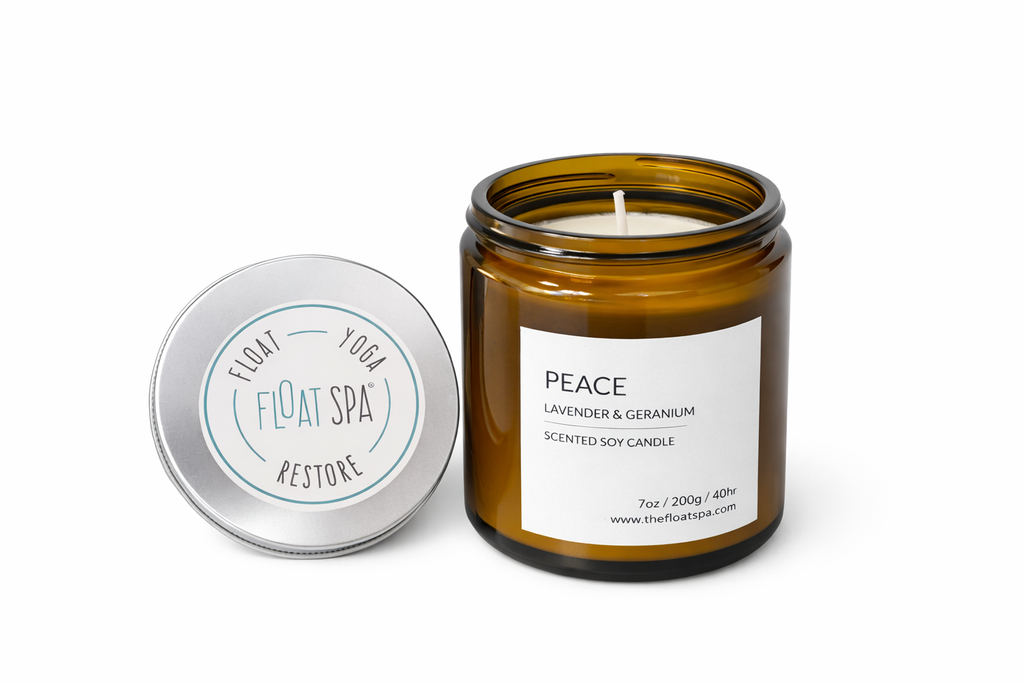 Brown candle jar with label and silver lid on a white background

